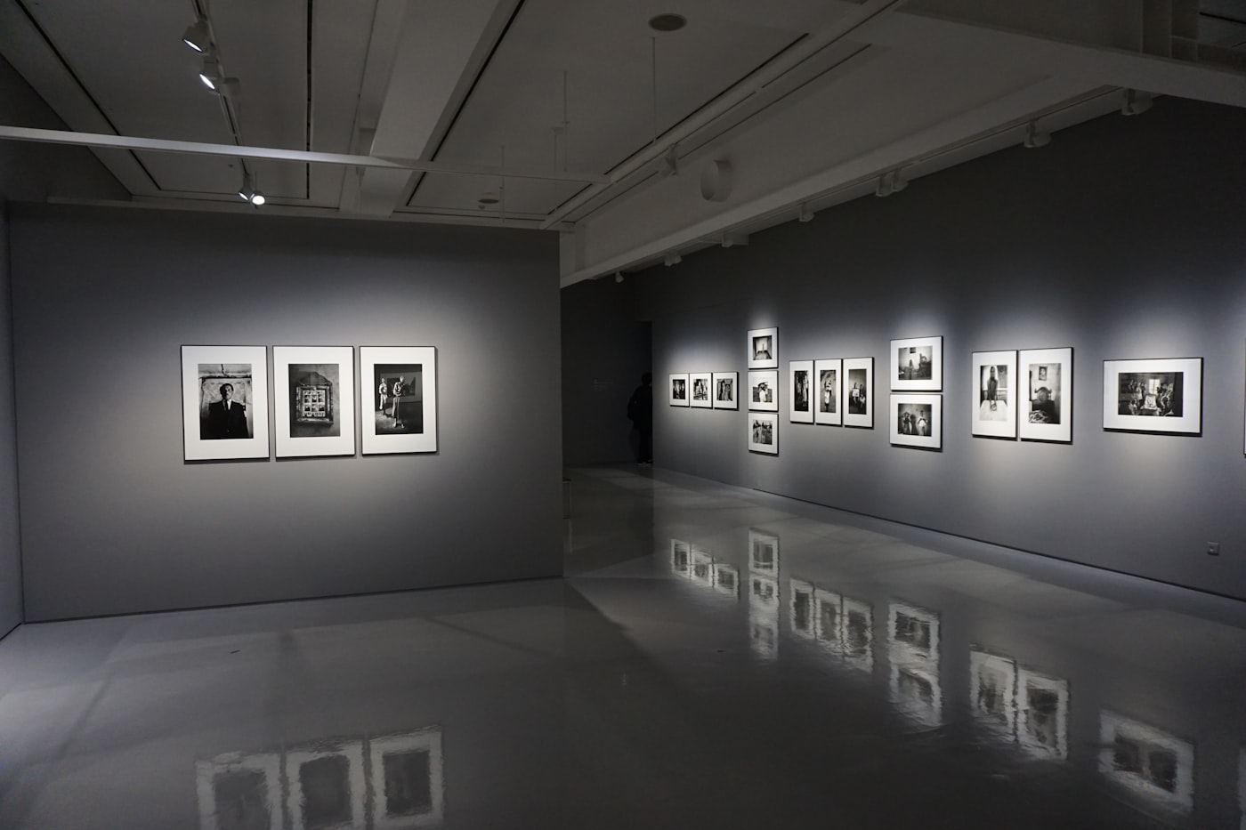 Dark gallery with black and white photography exhibition. Institutional art infrastructure